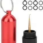 Portable scuba diving O-ring repair kit with brass pick and keychain capsule for emergency fixes.