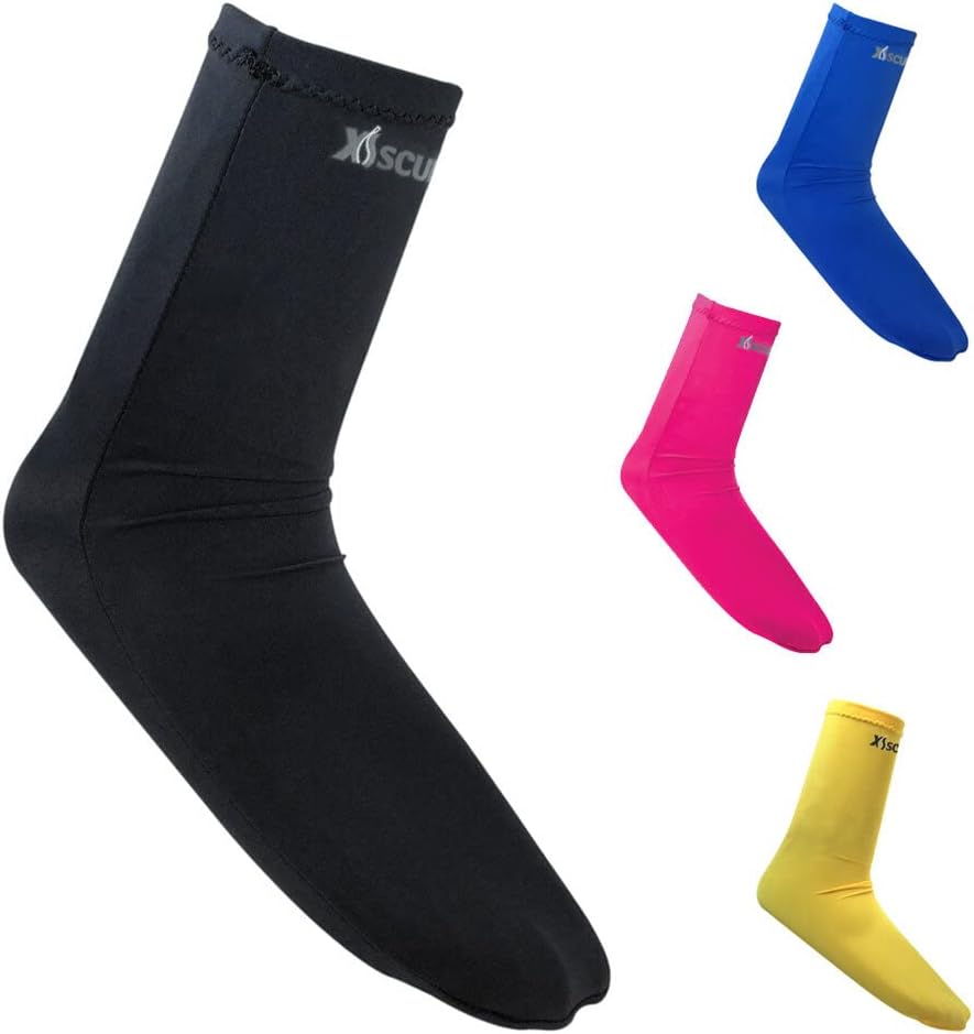 Four scuba diving lycra socks in black, blue, pink, and yellow are displayed on a white background. The socks are sleek and smooth, each featuring the "XS Scuba" logo near the top cuff.